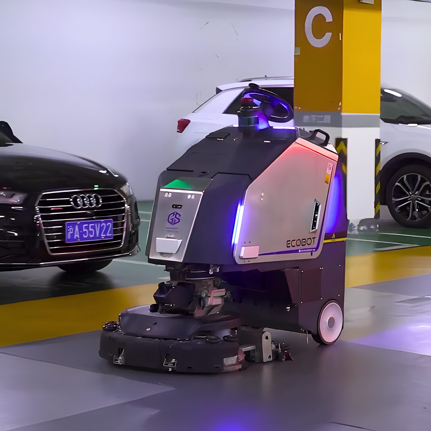 The Gausium Scrubber 75 rolling autonomously through a parking garage cleaning the floors.