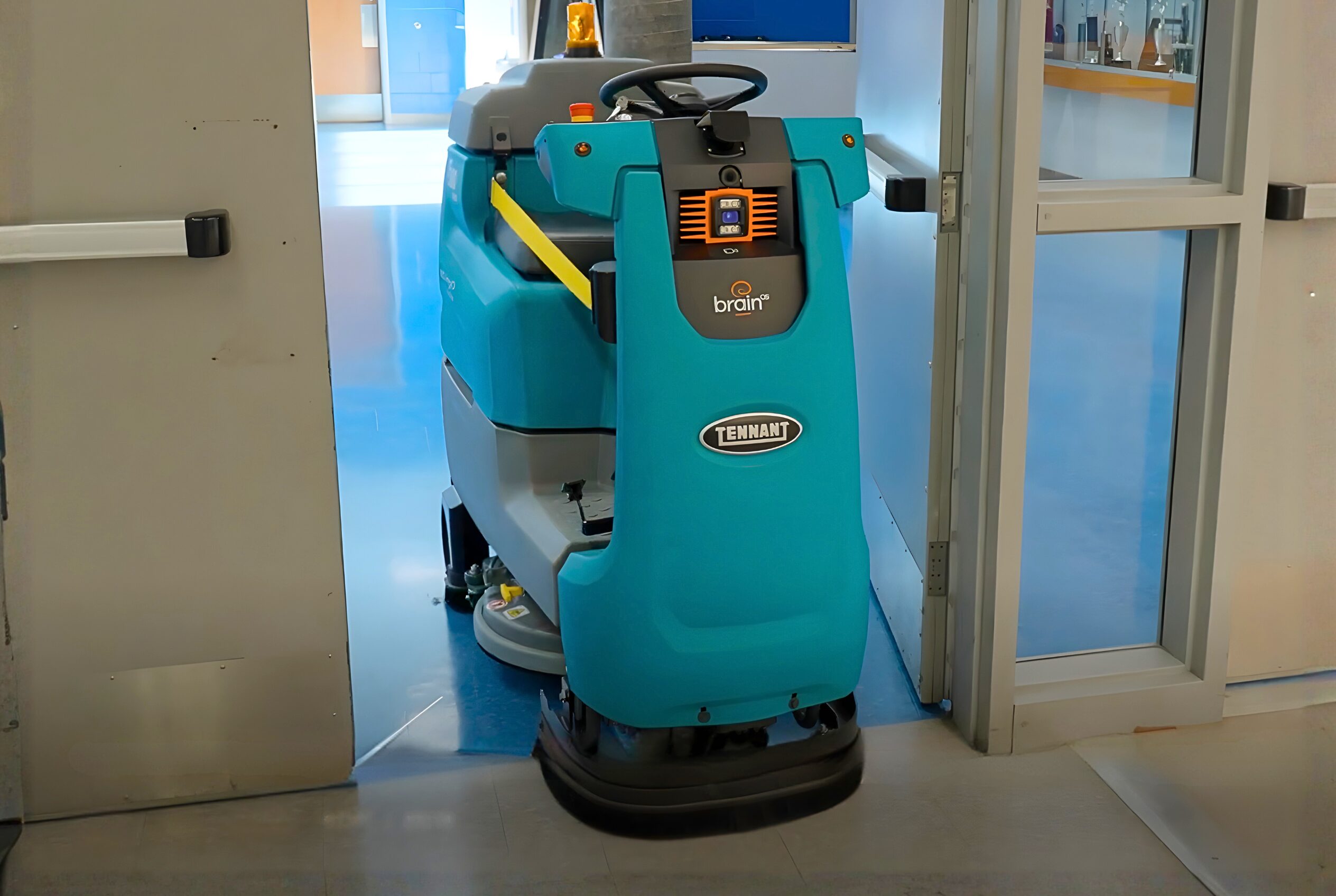 The Tennant T380AMR robotic floor cleaner navigating autonomously through a doorway.