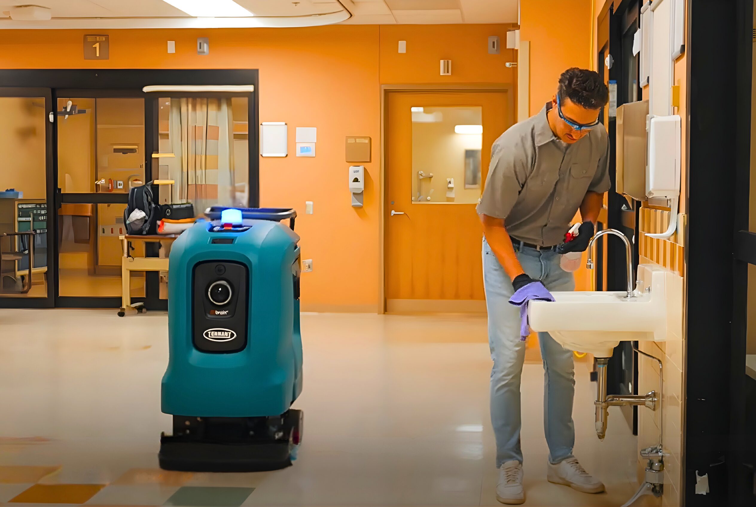 The Tennant X4 ROVR floor cleaning robot works along a human cleaner doing a more human necessar task.